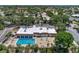 Aerial view of community pool, clubhouse, and surrounding landscape at 2505 Riverbluff Pkwy # V196, Sarasota, FL 34231