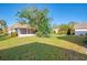 Private backyard with a screened patio and lush greenery at 2505 Riverbluff Pkwy # V196, Sarasota, FL 34231