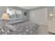 Guest bedroom with twin beds and floral bedding at 2505 Riverbluff Pkwy # V196, Sarasota, FL 34231