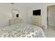 Bedroom with floral bedding, dresser, and en-suite bathroom at 2505 Riverbluff Pkwy # V196, Sarasota, FL 34231