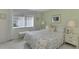 Bedroom with floral bedding, nightstands, and window with blinds at 2505 Riverbluff Pkwy # V196, Sarasota, FL 34231