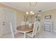 Well-lit dining room with an oval table and chairs, adjacent to kitchen at 2505 Riverbluff Pkwy # V196, Sarasota, FL 34231
