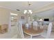 Spacious dining room with an oval table, chairs, and view into the kitchen at 2505 Riverbluff Pkwy # V196, Sarasota, FL 34231