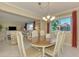 Bright dining area with an oval table and chairs, offering a view of the living room at 2505 Riverbluff Pkwy # V196, Sarasota, FL 34231