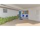 Covered entry with blue door and seating area at 2505 Riverbluff Pkwy # V196, Sarasota, FL 34231
