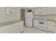 View of white kitchen cabinets, granite counters, and appliances at 2505 Riverbluff Pkwy # V196, Sarasota, FL 34231