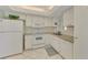 White kitchen with granite countertops and built-in microwave at 2505 Riverbluff Pkwy # V196, Sarasota, FL 34231