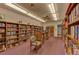 Community library filled with bookshelves and comfortable seating at 2505 Riverbluff Pkwy # V196, Sarasota, FL 34231