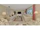 Bright living room with comfy sofas, a coffee table, and large windows at 2505 Riverbluff Pkwy # V196, Sarasota, FL 34231