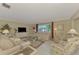 Spacious living room with light colored furniture at 2505 Riverbluff Pkwy # V196, Sarasota, FL 34231