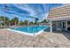 Inviting community pool with patio furniture and lush landscaping at 2505 Riverbluff Pkwy # V196, Sarasota, FL 34231