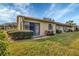 Exterior view of the home with well-maintained lawn at 2709 60Th Avenue N Plz # D, Bradenton, FL 34207