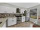 Updated kitchen featuring white cabinets, stainless steel appliances, and a tile backsplash at 2709 60Th Avenue N Plz # D, Bradenton, FL 34207