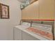 Laundry room with washer, dryer, and overhead cabinets at 2709 60Th Avenue N Plz # D, Bradenton, FL 34207
