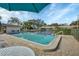 Community pool with lounge chairs and patio table at 2709 60Th Avenue N Plz # D, Bradenton, FL 34207