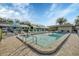 Community pool with lounge chairs and patio area at 2709 60Th Avenue N Plz # D, Bradenton, FL 34207