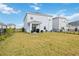 Spacious backyard with patio and a view of neighboring houses at 3408 Hilltop Cir, Bradenton, FL 34211