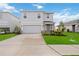 Two-story house with gray siding, stone accents, and a two-car garage at 3408 Hilltop Cir, Bradenton, FL 34211