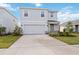 Two-story house with gray siding, stone accents, and a two-car garage at 3408 Hilltop Cir, Bradenton, FL 34211