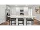 Modern kitchen with white cabinets, quartz countertops and island at 3408 Hilltop Cir, Bradenton, FL 34211