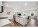 Open concept kitchen features a large island, white cabinets, and stainless steel appliances at 3408 Hilltop Cir, Bradenton, FL 34211