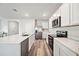 Modern kitchen with white cabinets, stainless steel appliances and quartz countertops at 3408 Hilltop Cir, Bradenton, FL 34211