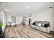 Open concept living room with gray couch and views to kitchen and dining areas at 3408 Hilltop Cir, Bradenton, FL 34211