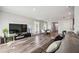 Spacious living room with a large TV and hardwood floors at 3408 Hilltop Cir, Bradenton, FL 34211