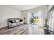 Living room with gray couch and sliding doors leading to the backyard at 3408 Hilltop Cir, Bradenton, FL 34211