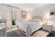 Bright bedroom with a comfortable queen-size bed and wicker furniture at 3421 Clark Rd # 122, Sarasota, FL 34231