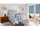 Charming bedroom with antique brass bed frame and window seat at 3421 Clark Rd # 122, Sarasota, FL 34231