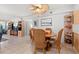 Bright dining area with wicker chairs and a wood table, adjacent to kitchen at 3421 Clark Rd # 122, Sarasota, FL 34231