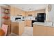 Modern kitchen with light wood cabinets, white backsplash, and black appliances at 3421 Clark Rd # 122, Sarasota, FL 34231
