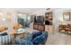 Relaxing living room with comfortable seating, large TV, and built-in shelving at 3421 Clark Rd # 122, Sarasota, FL 34231