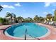 Refreshing community pool surrounded by palm trees at 3421 Clark Rd # 122, Sarasota, FL 34231