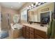 Bathroom features a double vanity, garden tub, and walk-in shower at 3439 101St E Ave, Parrish, FL 34219