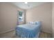 Bedroom with queen bed, window, and ceiling fan at 3439 101St E Ave, Parrish, FL 34219