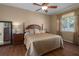Spacious bedroom with a king-size bed and wood furniture at 3439 101St E Ave, Parrish, FL 34219