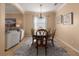 Bright dining room features a wood table with six chairs and a large window at 3439 101St E Ave, Parrish, FL 34219