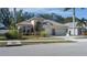 House exterior showcasing a three-car garage and manicured lawn at 3439 101St E Ave, Parrish, FL 34219