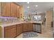 Kitchen with island, stainless steel appliances, and wood cabinets at 3439 101St E Ave, Parrish, FL 34219