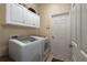 Laundry room with washer, dryer, and ample cabinet storage at 3439 101St E Ave, Parrish, FL 34219