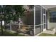 Screened porch with patio furniture and lush landscaping at 3439 101St E Ave, Parrish, FL 34219
