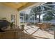 Relaxing screened porch with patio furniture and grill at 3439 101St E Ave, Parrish, FL 34219