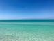 Beautiful beachfront showcasing clear, turquoise water meeting a white sand shore, offering scenic coastal living at 3710 Gulf Of Mexico Dr # D19, Longboat Key, FL 34228