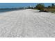 Long white beach with the sea in the background at 3710 Gulf Of Mexico Dr # D19, Longboat Key, FL 34228