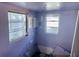 Bedroom showcasing charming purple walls, and two windows at 3710 Gulf Of Mexico Dr # D19, Longboat Key, FL 34228