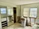Bedroom featuring a sliding mirror closet, with water damage and an adjacent side table at 3710 Gulf Of Mexico Dr # D19, Longboat Key, FL 34228