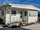 Charming single-story home with covered porch, manicured garden, and a relaxing outdoor space at 3710 Gulf Of Mexico Dr # D19, Longboat Key, FL 34228