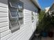 View of side of home featuring three awning windows and garden at 3710 Gulf Of Mexico Dr # D19, Longboat Key, FL 34228